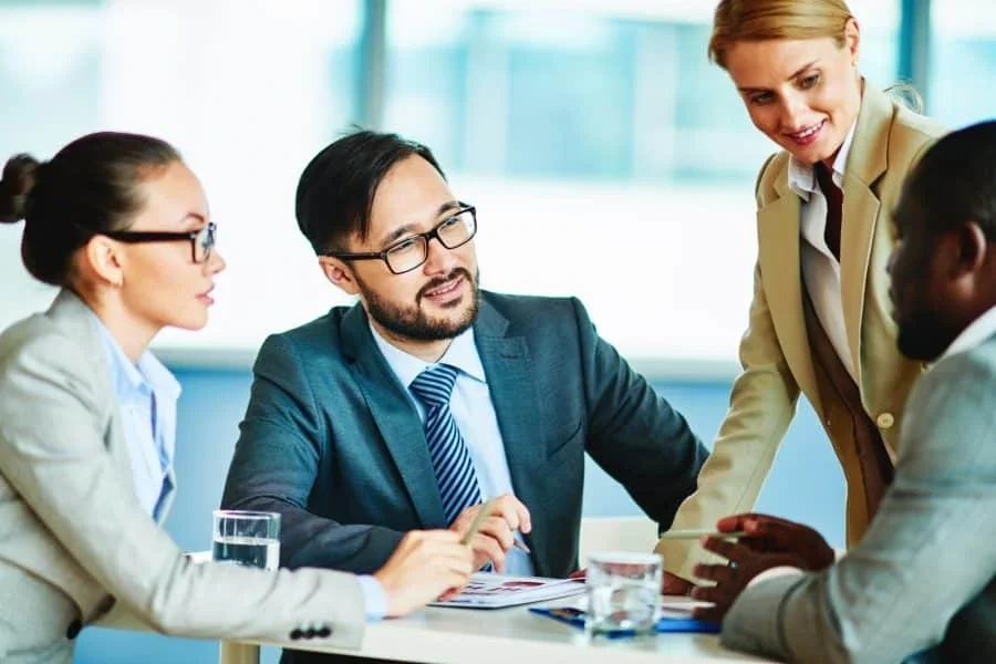 Consultant explaining AI strategy to diverse team
