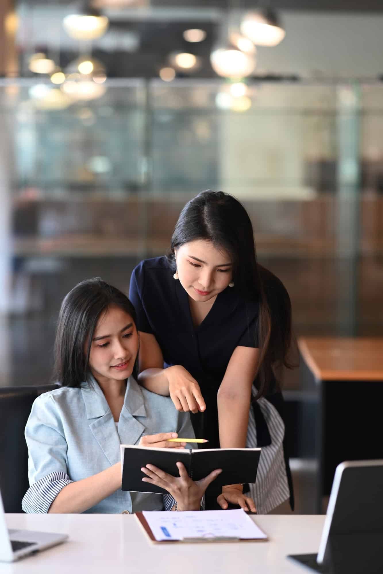 two ladies looking at Consulting report