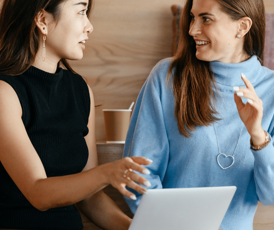 wo women engaged in a conversation, likely in a casual setting