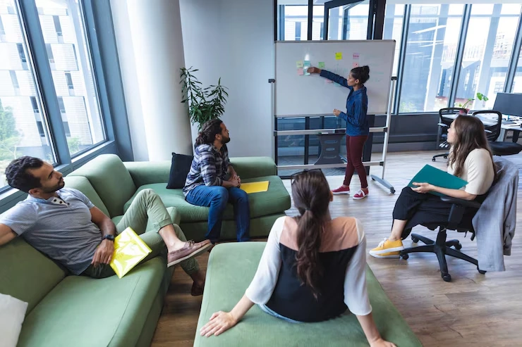 Team collaboration session in modern office with behavioral change training and workplace culture development