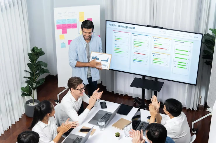 Business process optimization workshop with team analyzing project management dashboard and workflow charts