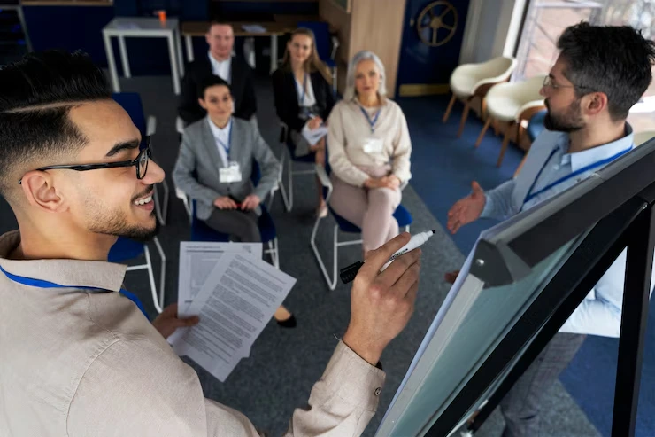Business consultant leading customer experience improvement workshop with flipchart and engaged participants