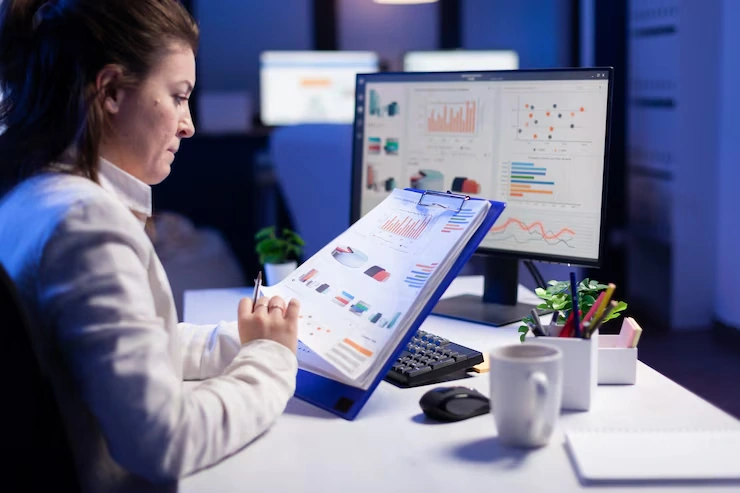 Professional woman analyzing data charts and analytics dashboard for business insights consultation