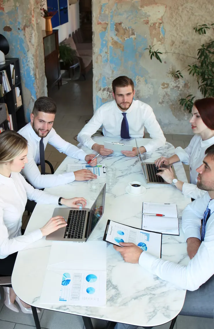 Professional team meeting with data analysis and organizational behavior consulting discussion in modern office