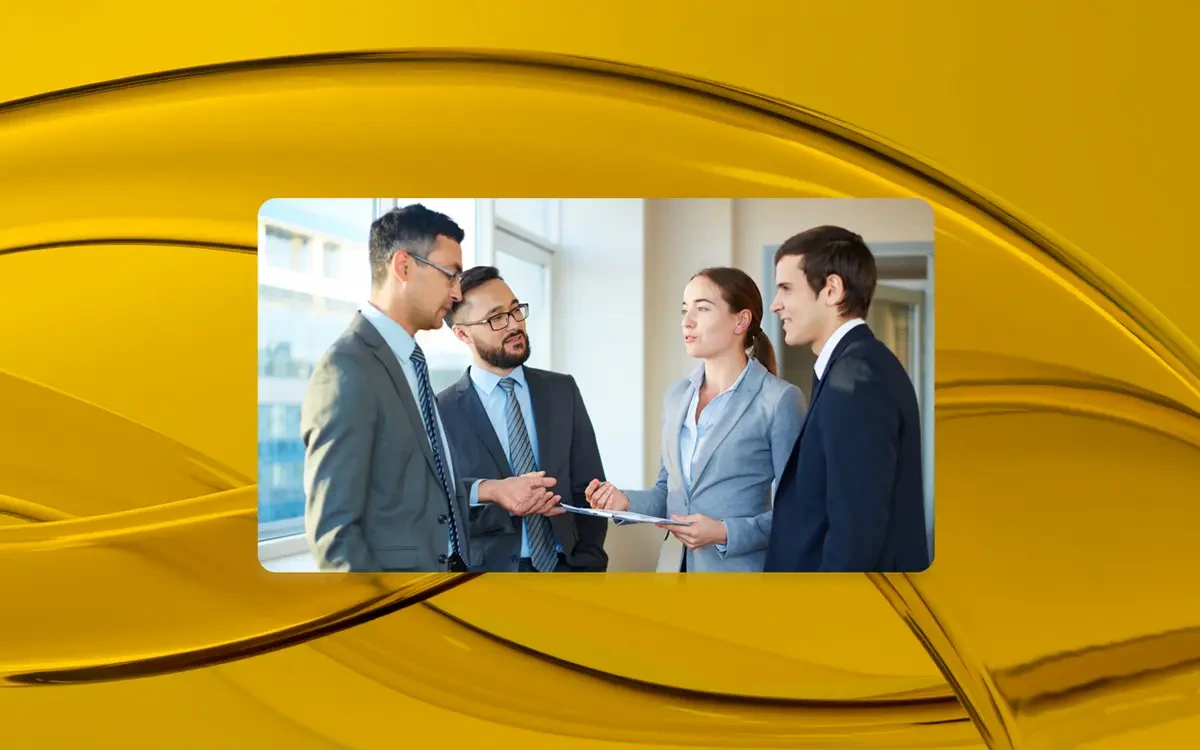 Four professionals discussing project documents