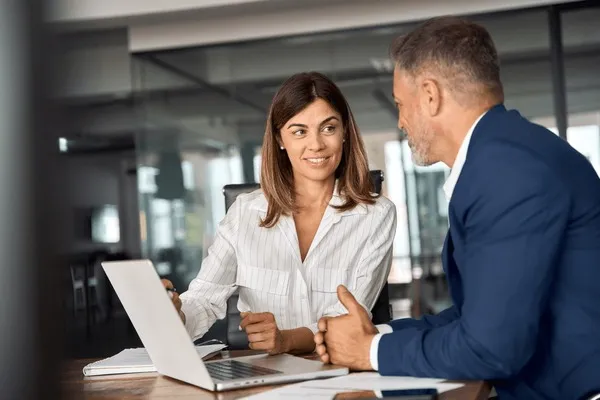 Industry analysts reviewing statistics report with charts and market data insights for business