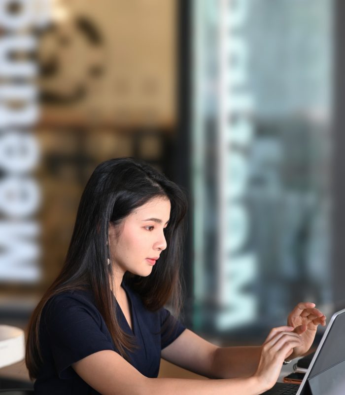 Portrait of businesswoman using tablet computer analyzing business data at her workplace.