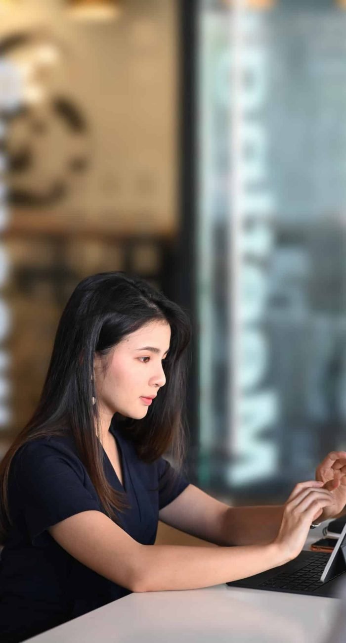 Portrait of businesswoman using tablet computer analyzing business data at her workplace.