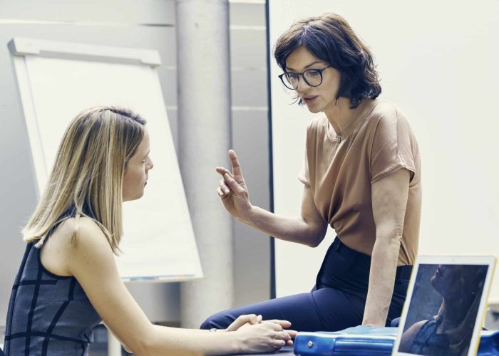 Two businesswomen having discussion in office meeting