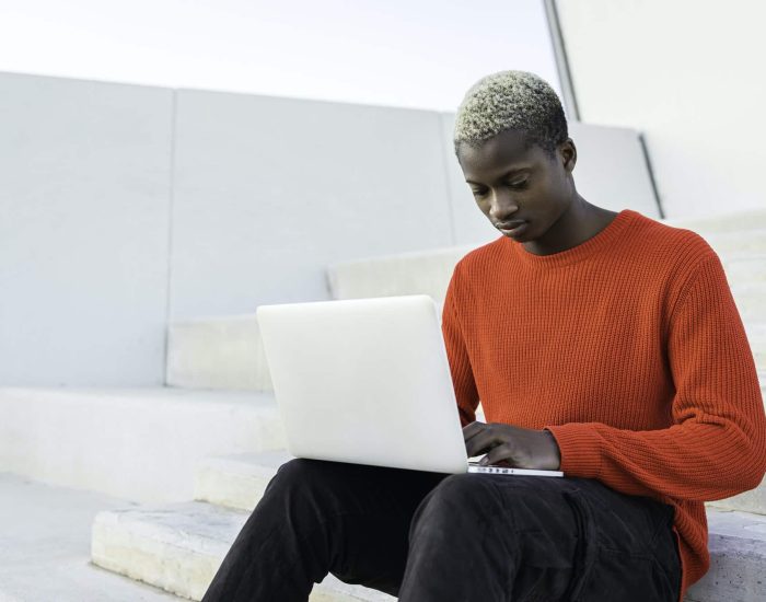 Young African american man with laptop computer.