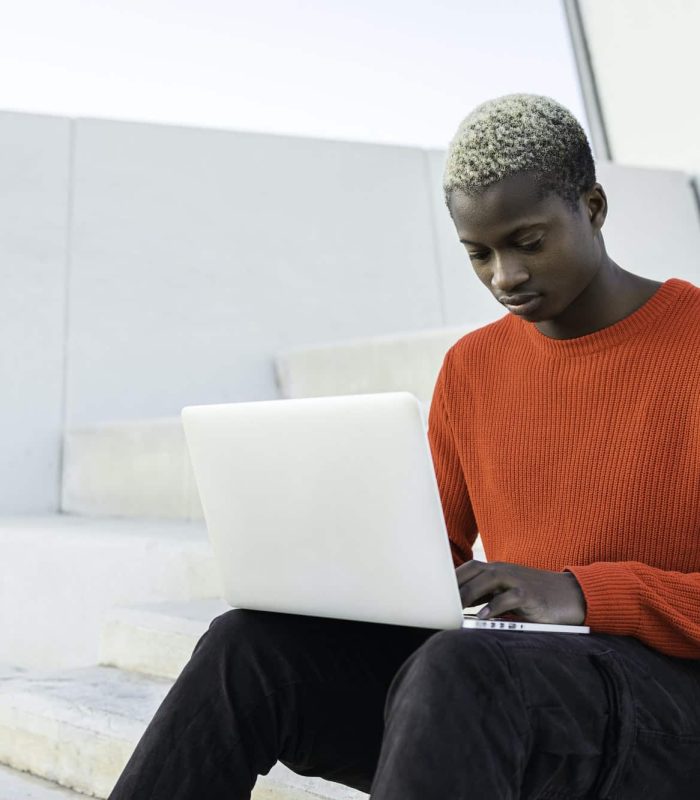 Young African american man with laptop computer.